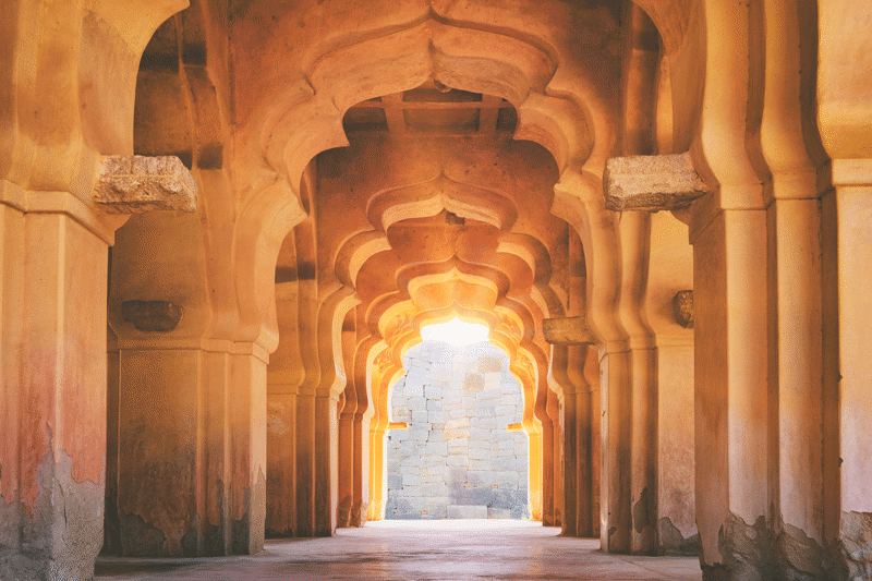 Lotus Mahal arches during sunset at the Hampi temple in India