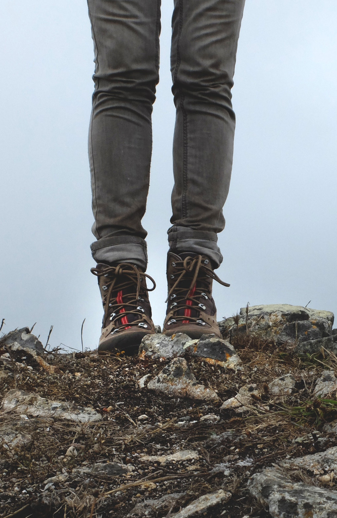 Close-up image of a woman's legs with hiking boots on her feet - KILROY