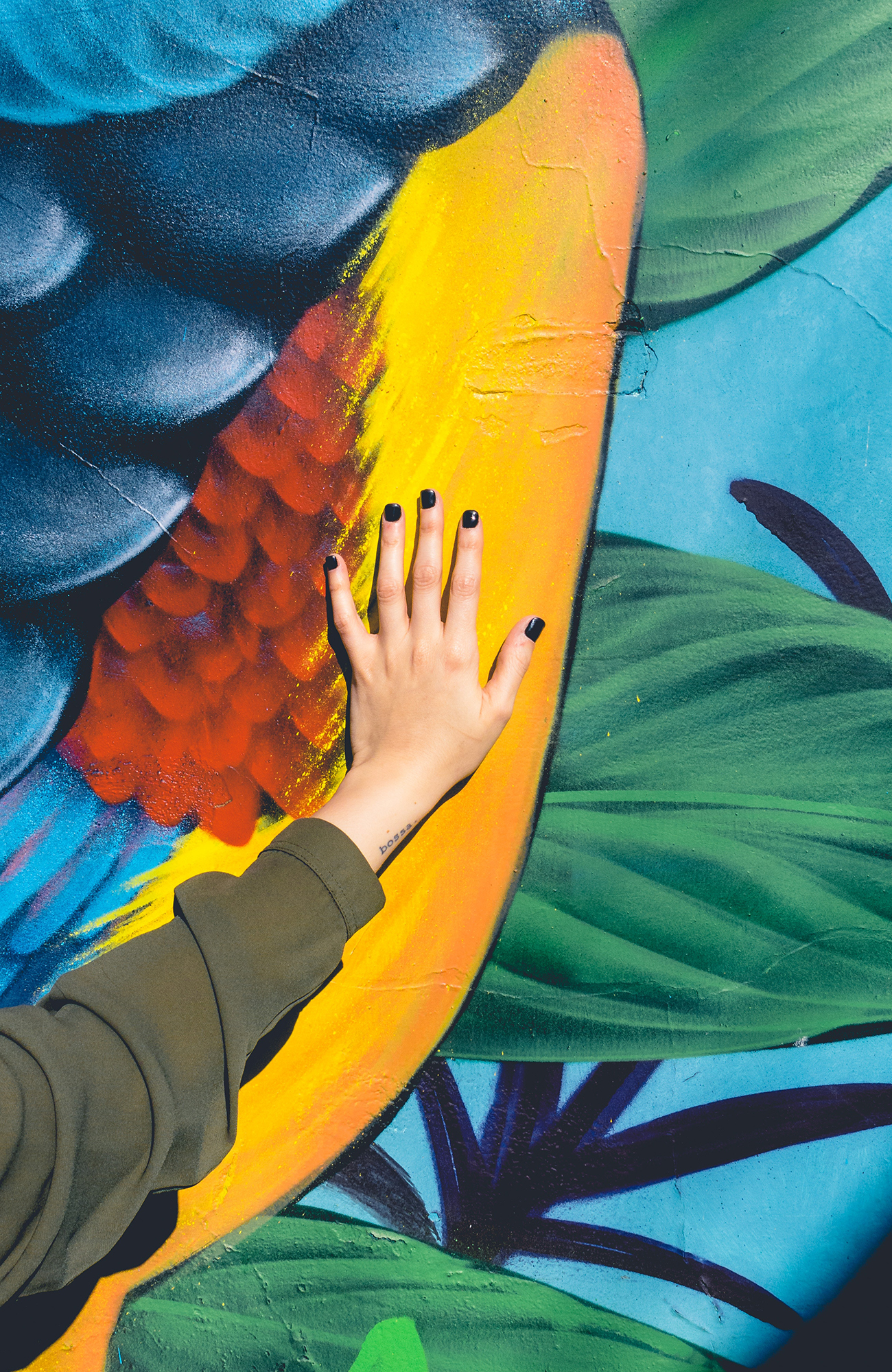 Image of a woman's hand on a colourful mural in Buenos Aires - KILROY