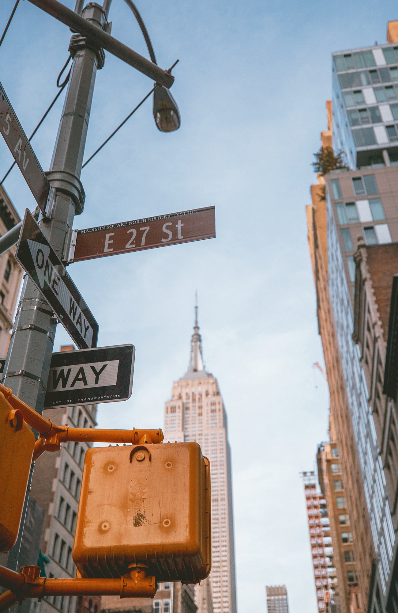 Image of road signs with a skyscraper in the background in New York City - KILROY