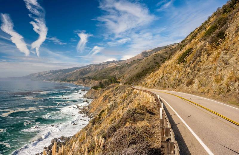 Panoramic highway 1 in California, hills on the right with an ocean view on the left