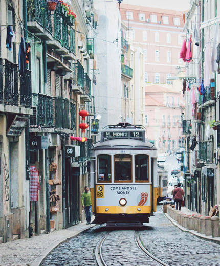 Image of a tram weaving its way through the streets of Lisbon in Portugal - KILROY
