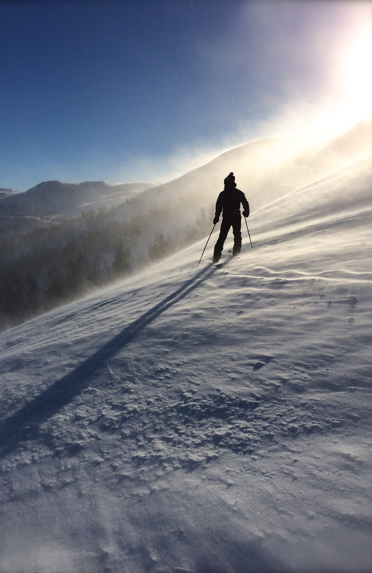Image of a skier stopped on a snowy slope in Canada - KILROY