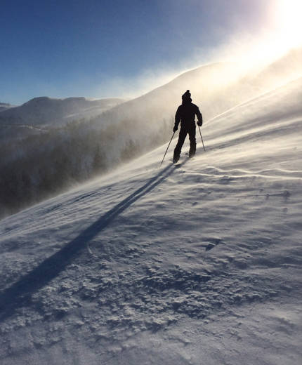 Image of a skier stopped on a snowy slope in Canada - KILROY