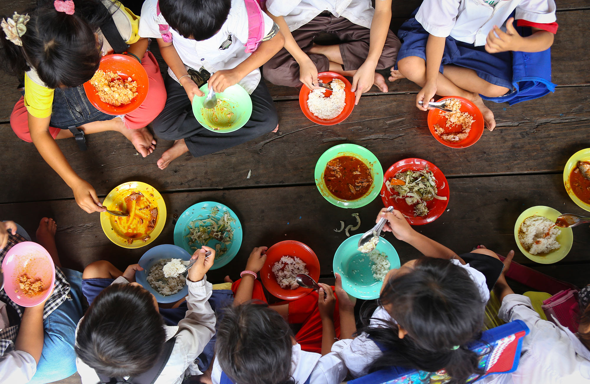 Aerial image of children eating lunch at a school in Cambodia - KILROY