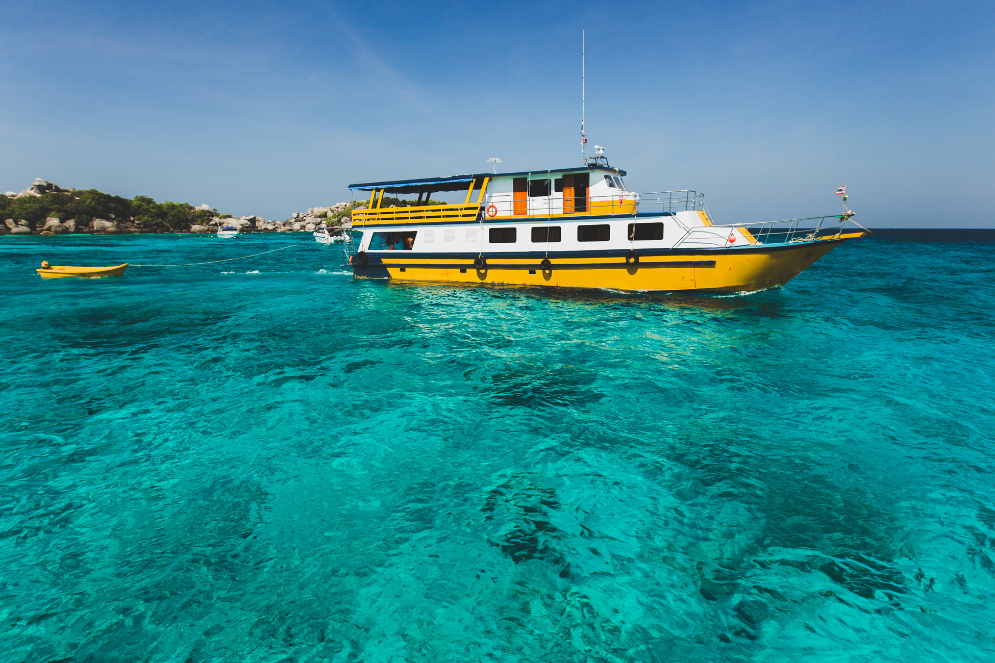 Image of a dive boat anchored in crystal-clear waters in Costa Rica - KILROY