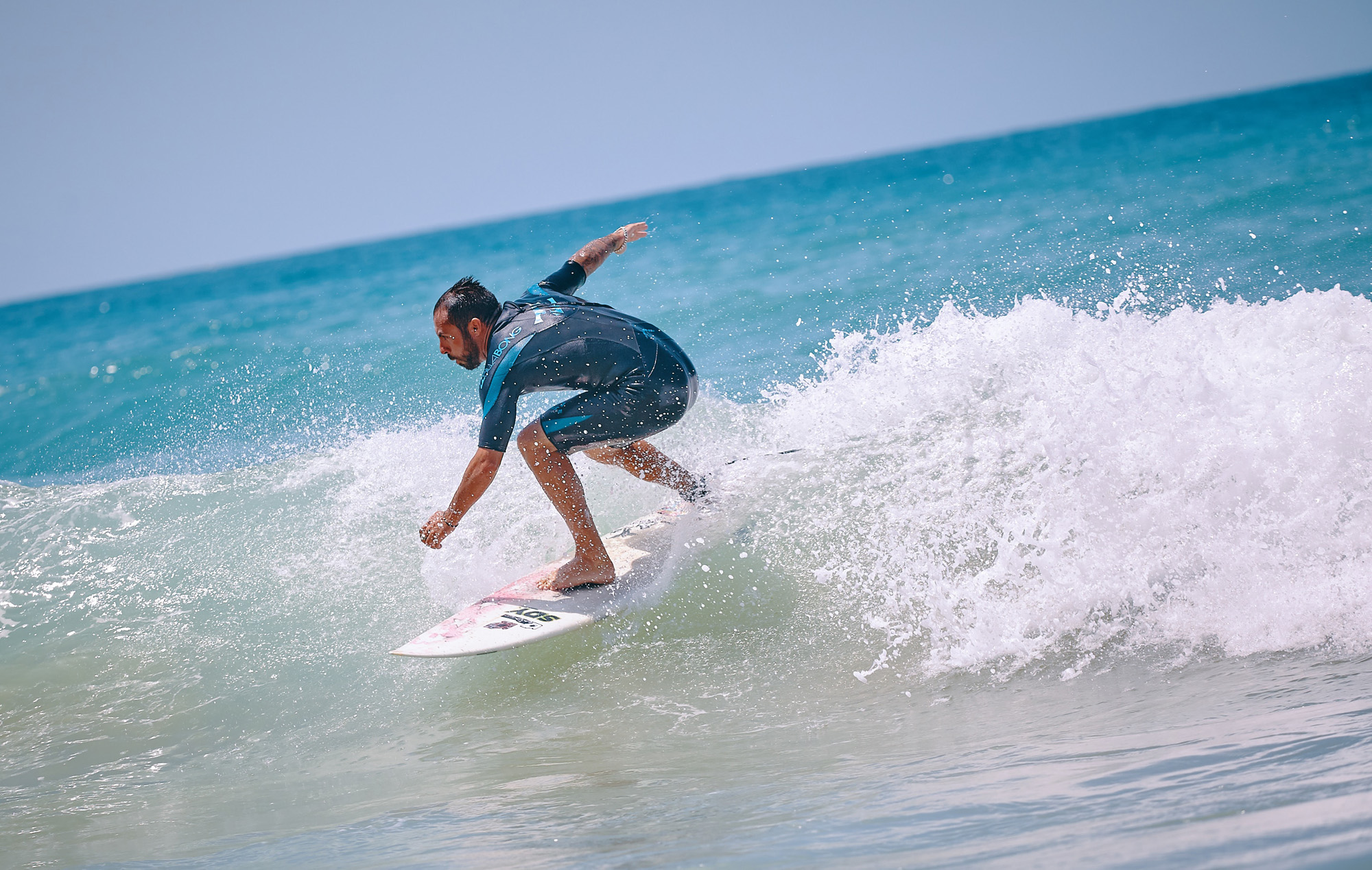 Image of a man surfing on a breaking wave - KILROY