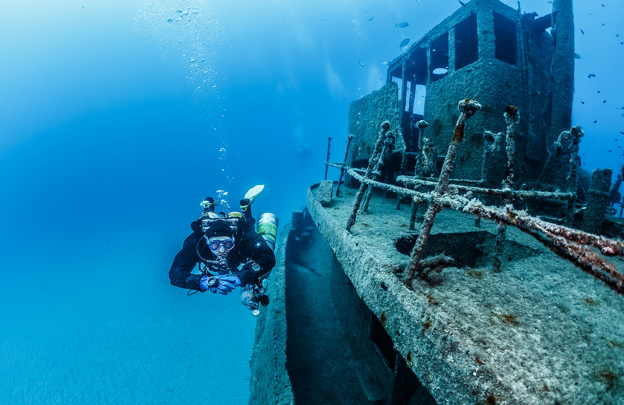 Image of a diver beside a ship wreck in the waters surrounding Malta - KILROY
