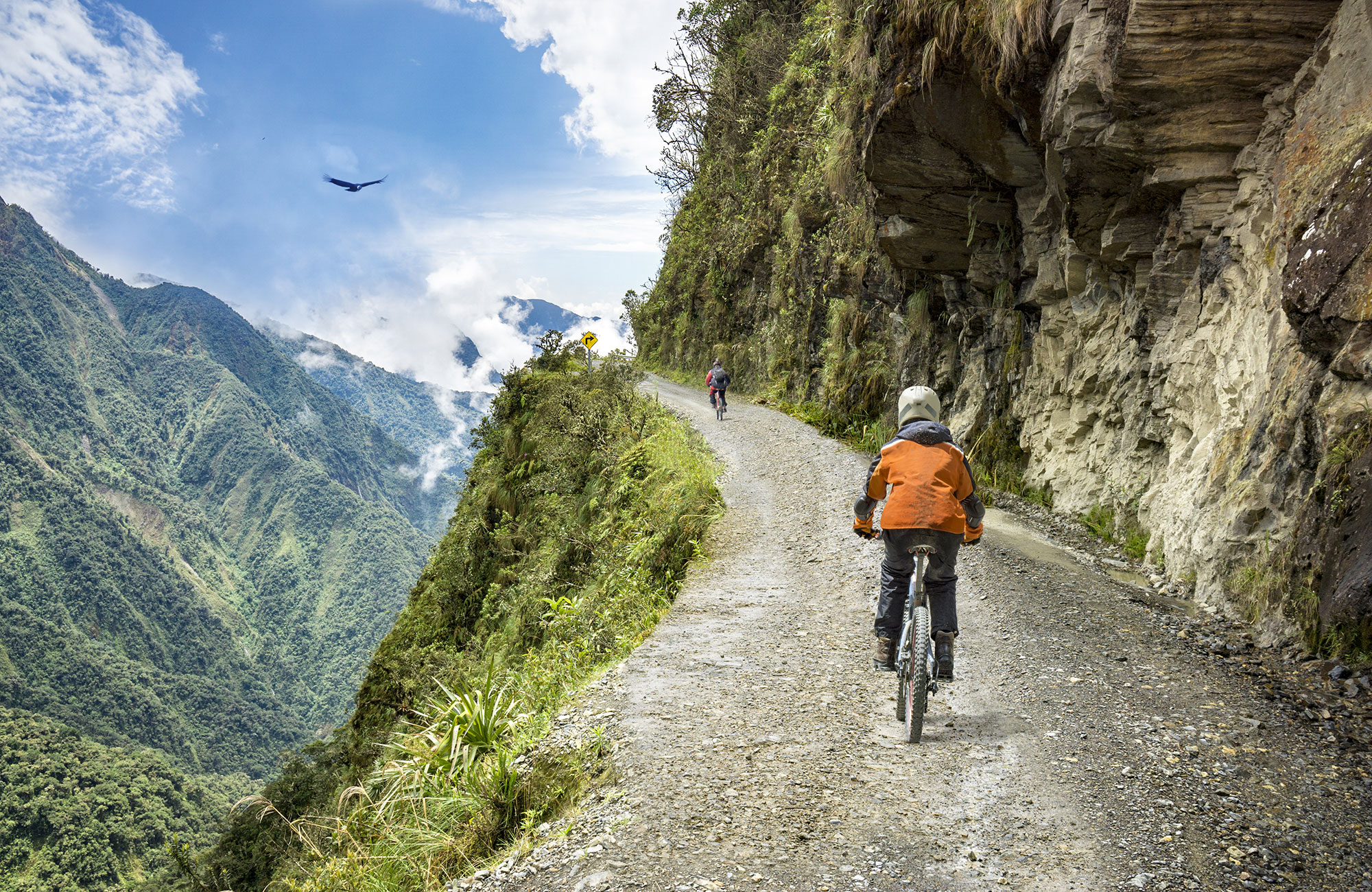 Image of two mountain bikers cycling uphill on the side of a mountain - KILROY