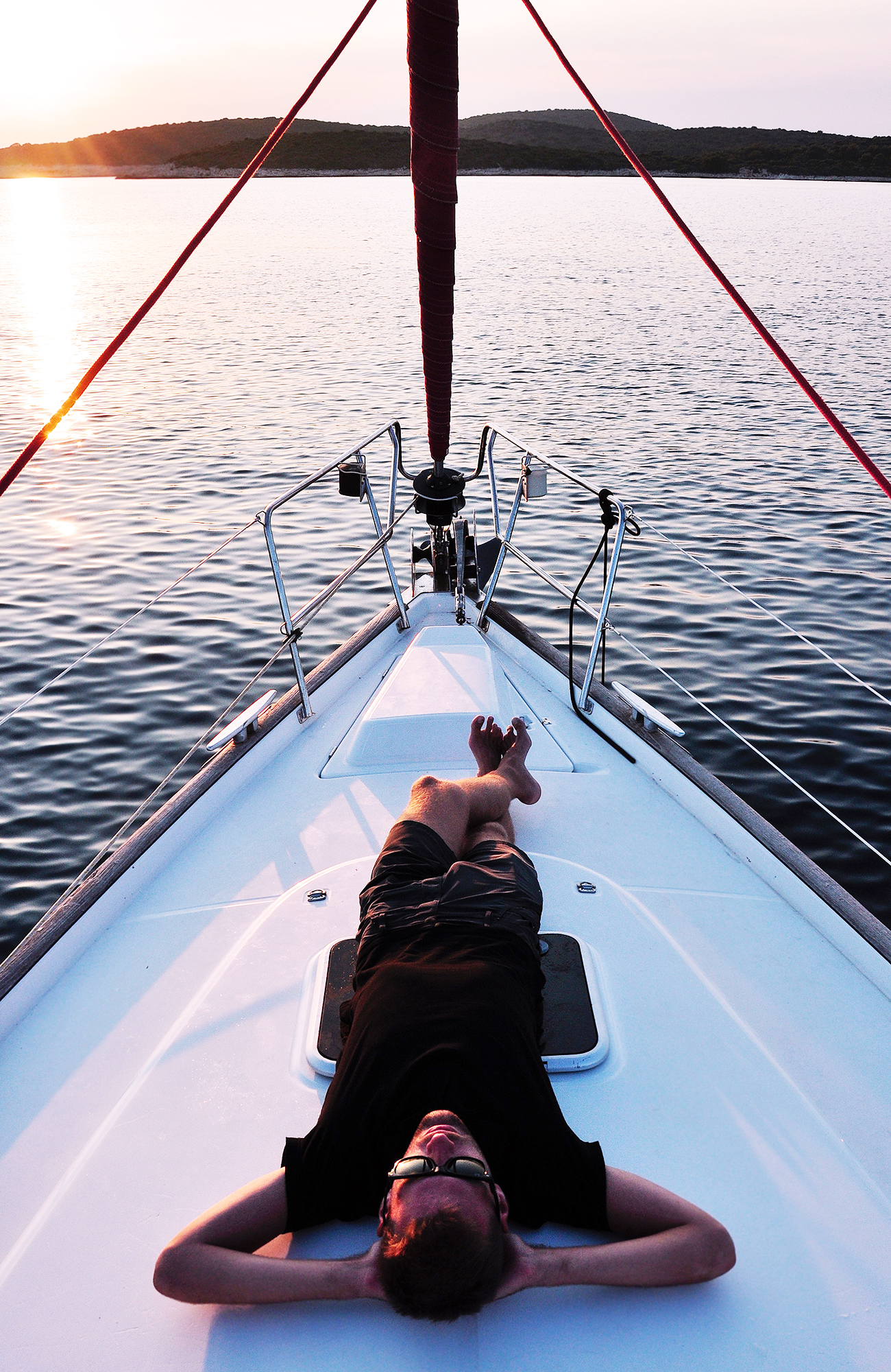 Image of a man relaxing on a sailing boat - KILROY