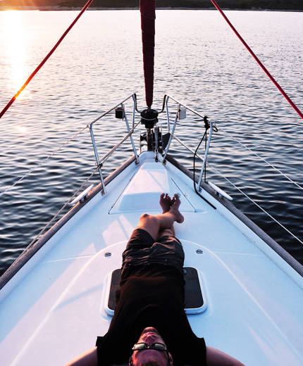 Image of a man relaxing on a sailing boat - KILROY
