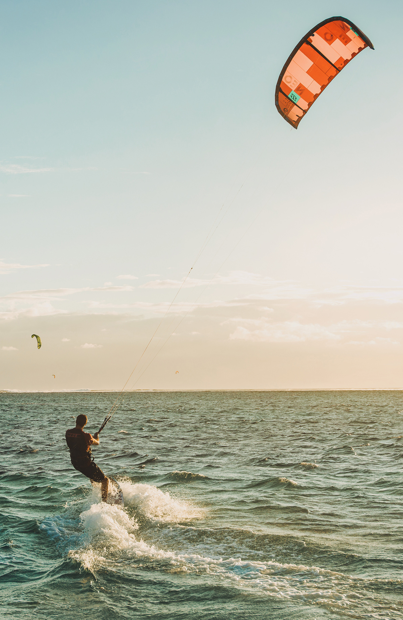 Image of a man kitesurfing - KILROY