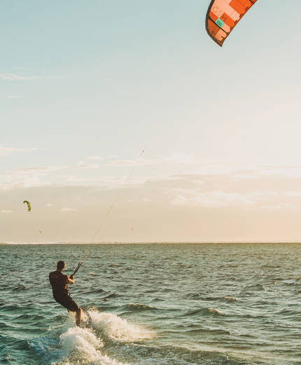 Image of a man kitesurfing - KILROY