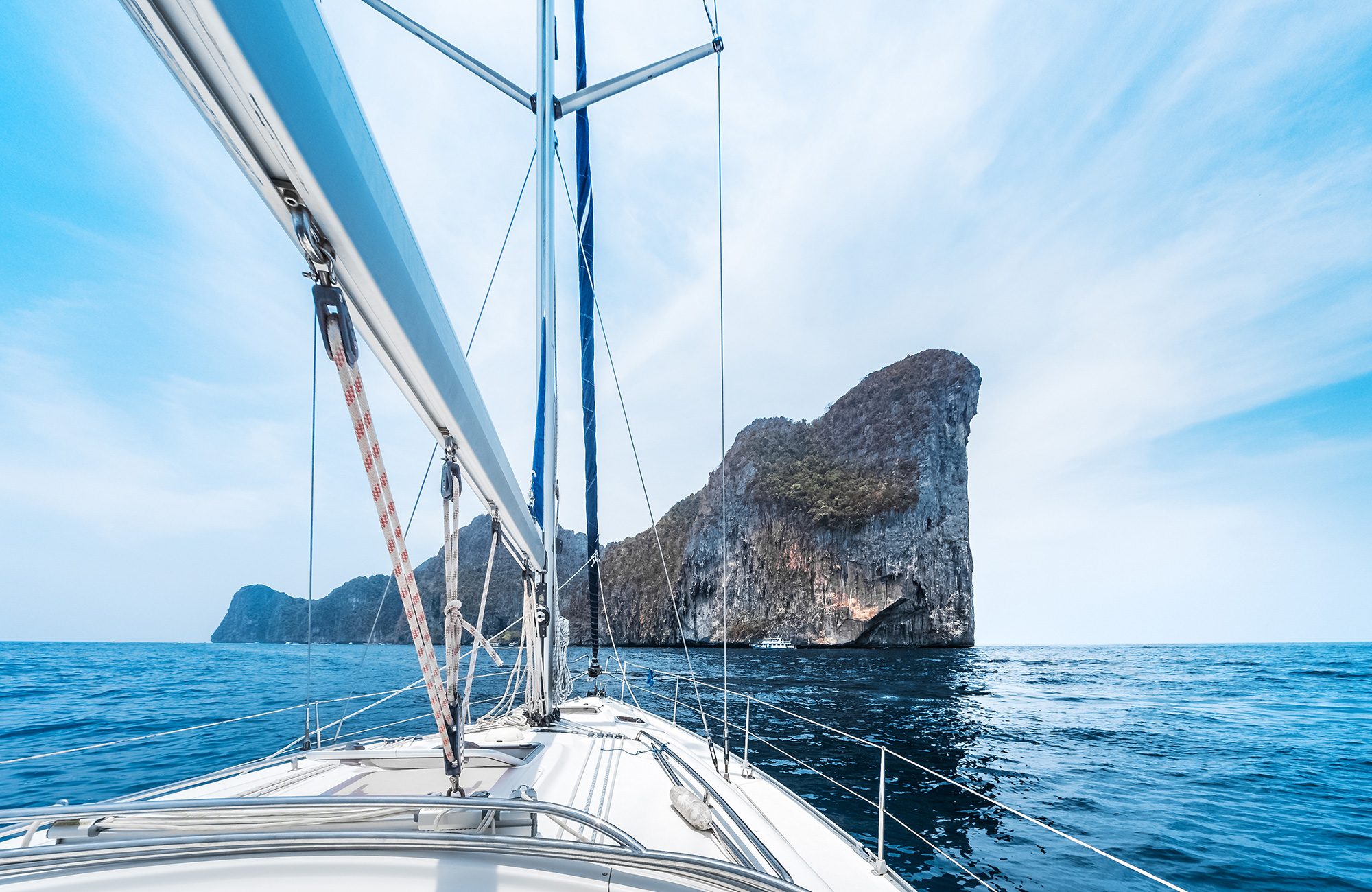 Image of a sailing boat headed towards a karst island in Thailand - KILROY