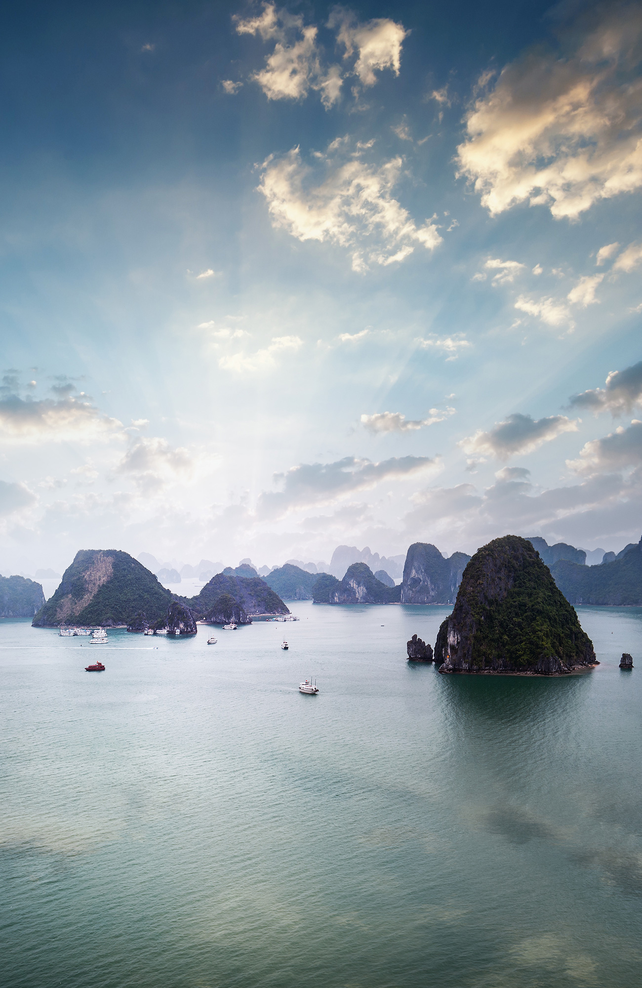 Image of karst islands and sail boats in Halong Bay in Vietnam - KILROY