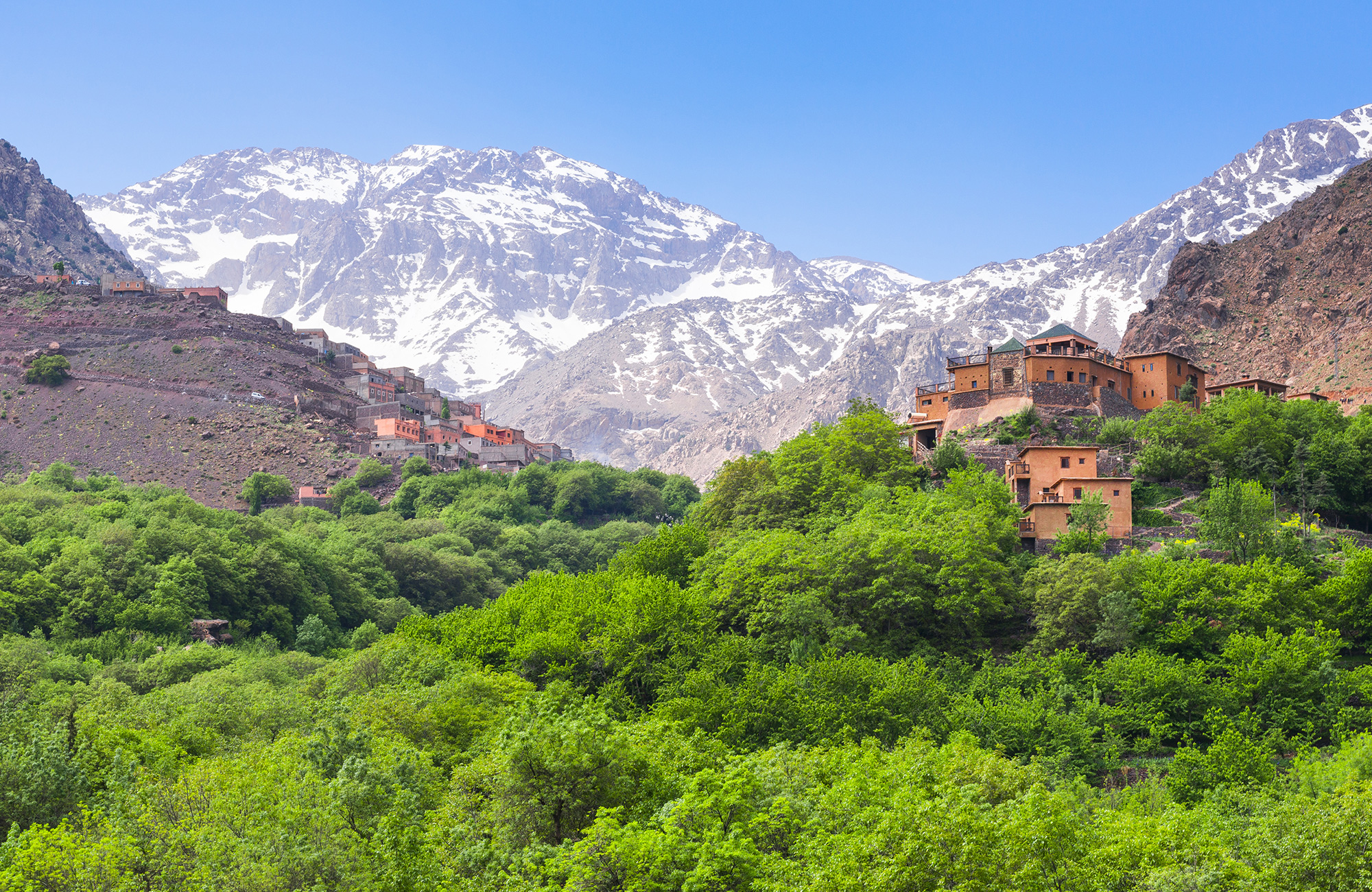 Image of a village in the High Atlas Mountains in Morocco with a peak in the background - KILROY