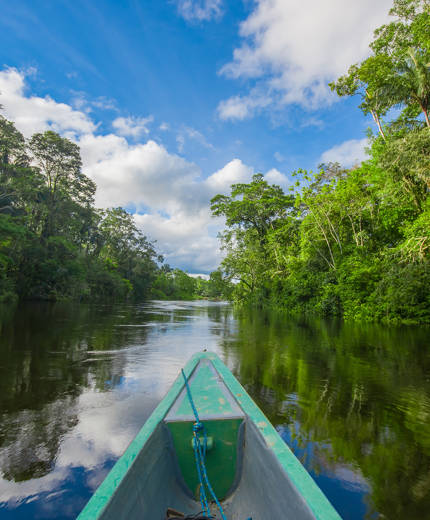 Image of a boat on a river in the Amazon - KILROY