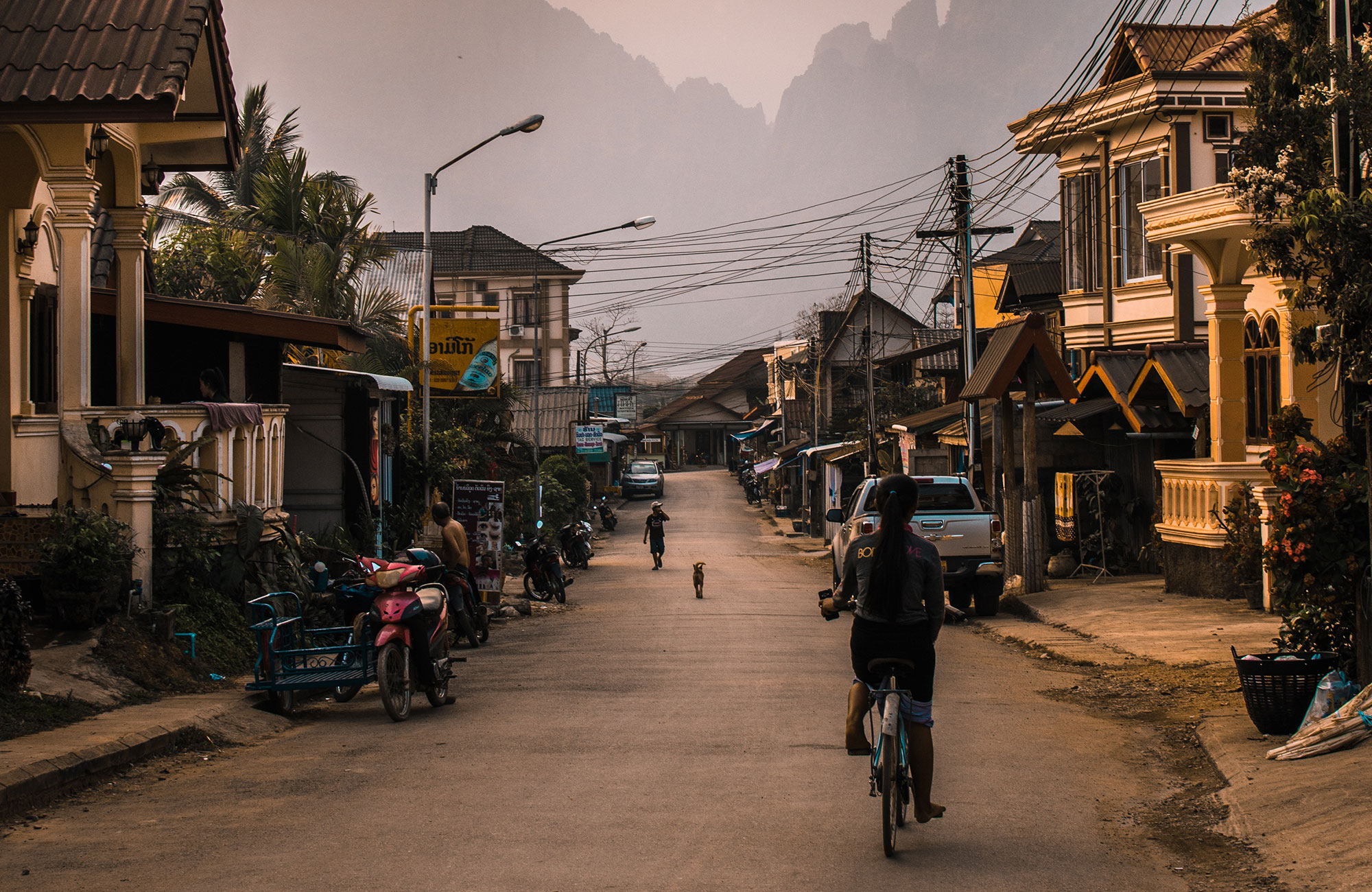 Image of a traditional village scene in Laos - KILROY
