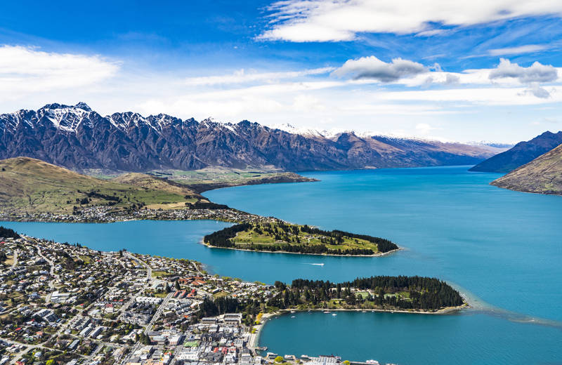 Image looking out across the city of Queenstown and the surrounding mountain and lake in New Zealand - KILROY