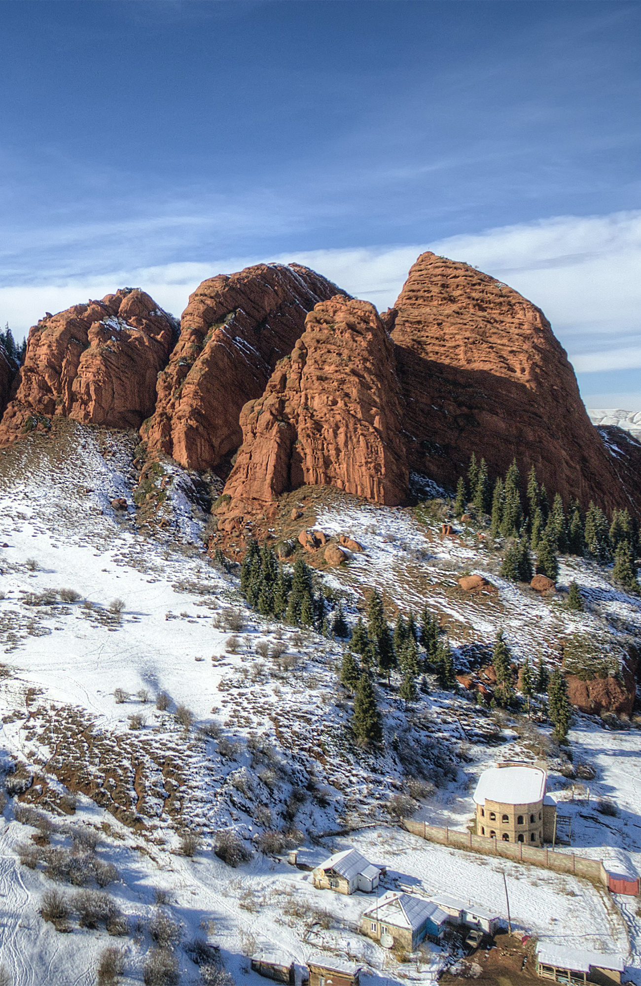 Image of a snow-covered landscape in Kyrgyzstan with rugged hilltops - KILROY