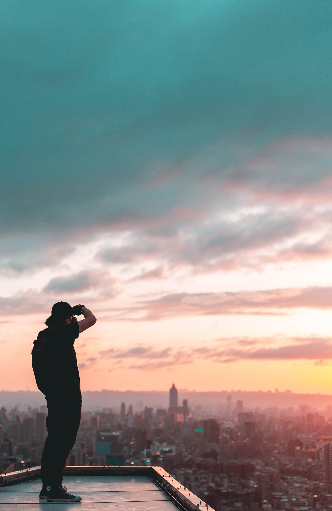 Image of a man taking photos of the Taipei skyline in Taiwan - KILROY