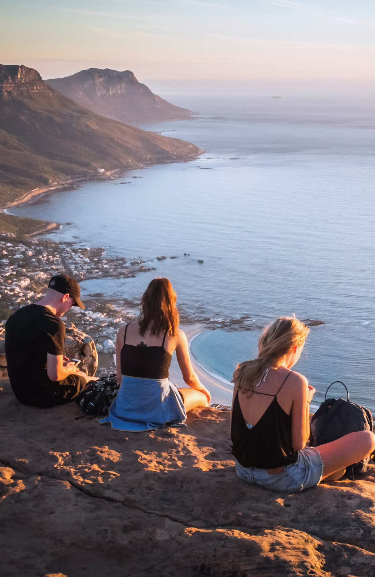 Image of travellers sat overlooking the city of Cape Town on an adventure tour in Africa - KILROY
