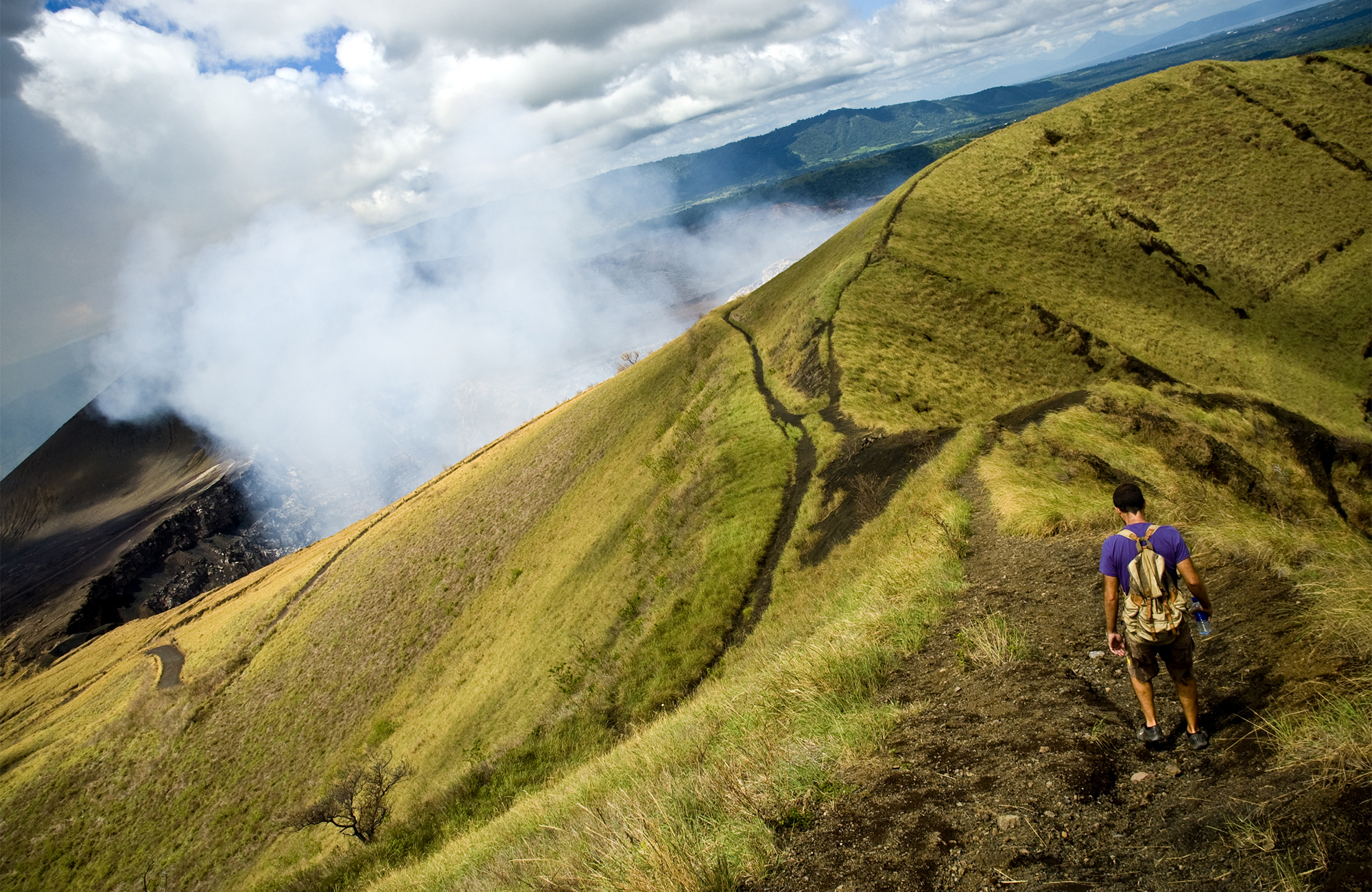 Image of a hill leading to a smoking volcano in Nicaragua - KILROY