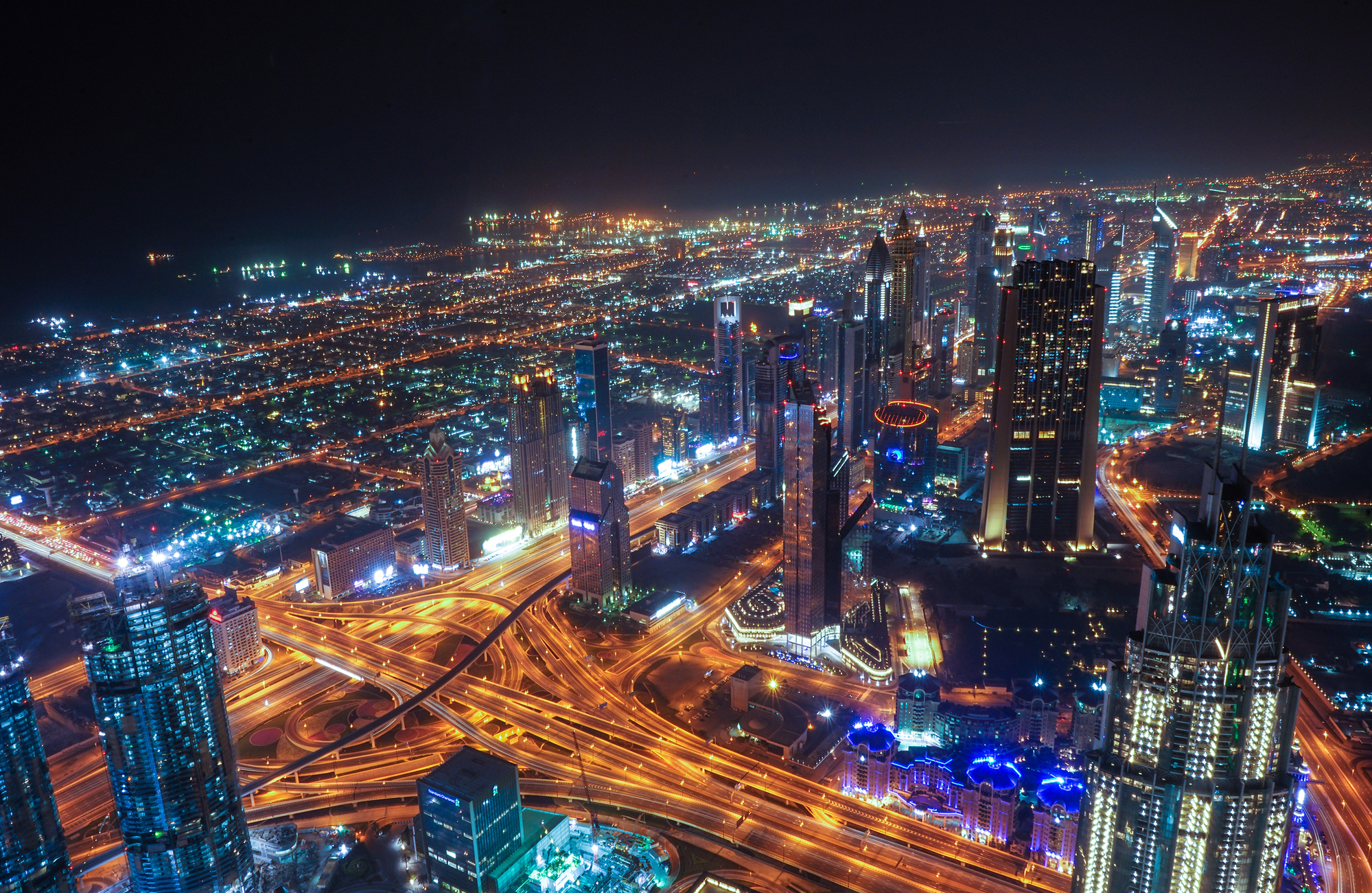 Aerial image of Dubai's city skyline at night in the United Arab Emirates - KILROY