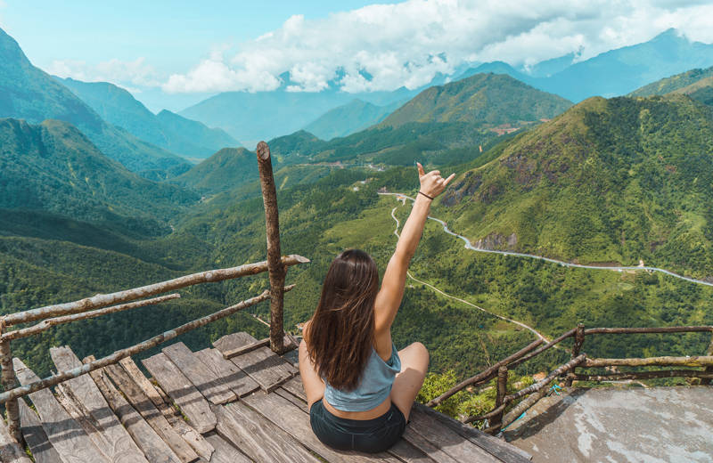 Image of a young female traveller at a lookout point in Northern Vietnam - KILROY