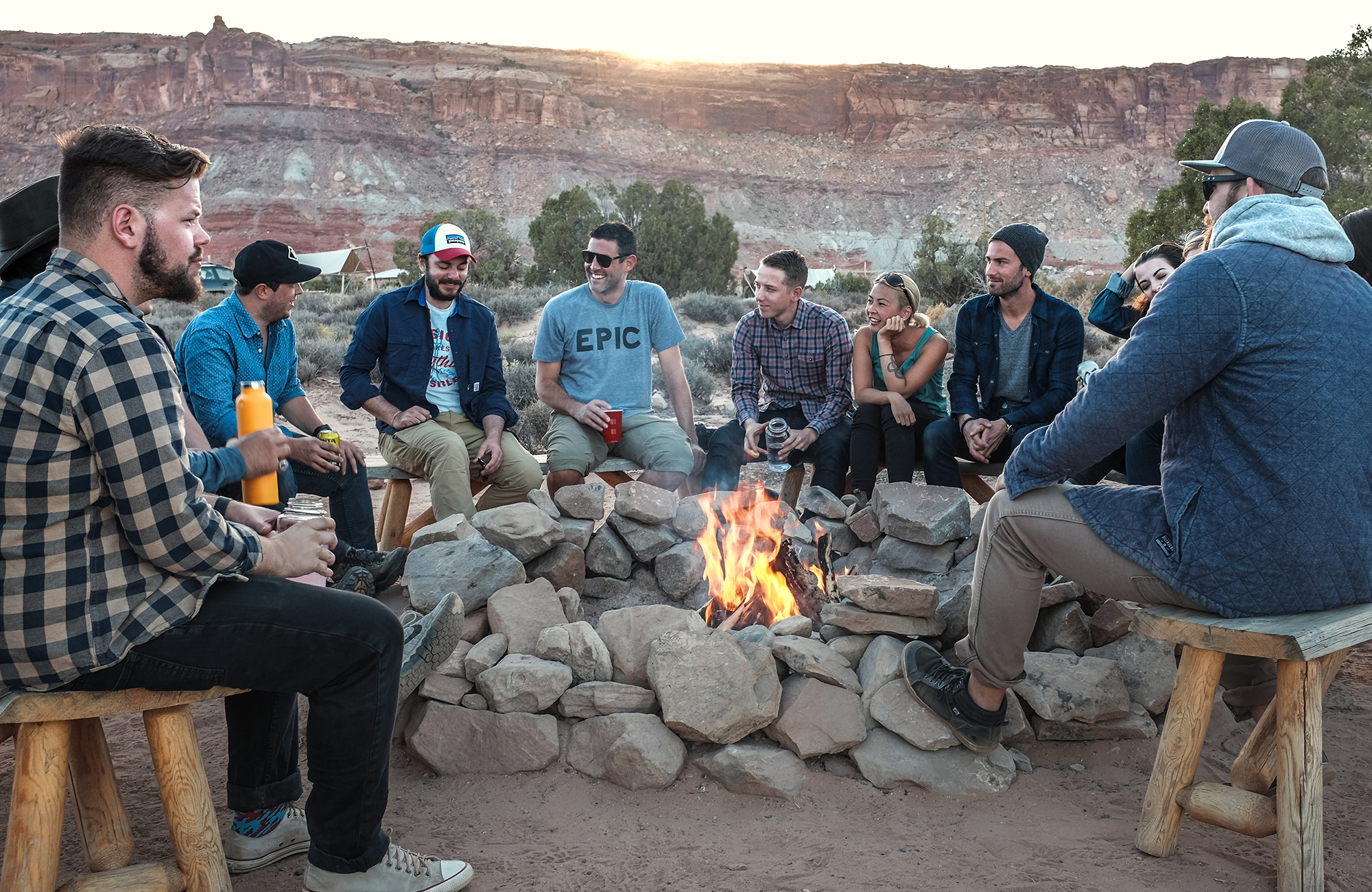 Image of a group of travellers around a campfire in the desert in North America - KILROY