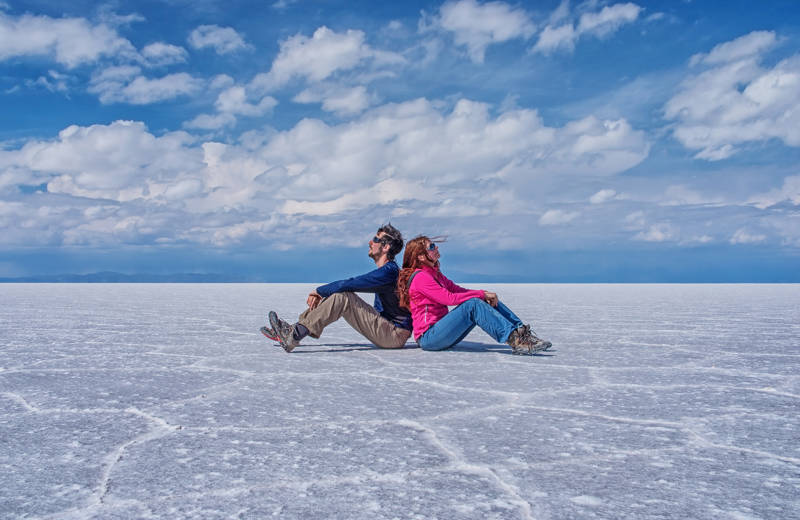 Image of a couple posing on the salt flats of Uyuni in Bolivia - KILROY