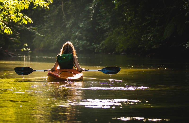 A girl kayaking on a river in Costa Rica