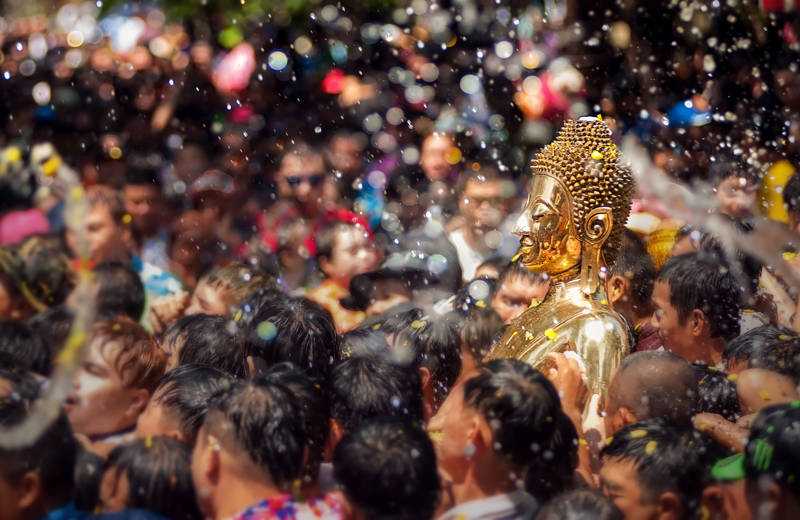 A golden Buddha carried through the crowds during the Songkran festival in Thailand