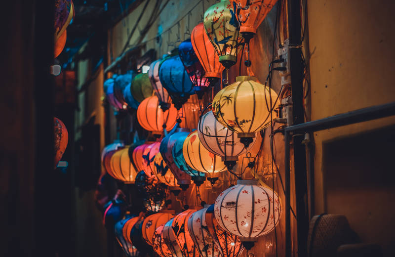 Image of lanterns hanging against a building wall in Hoi An in Vietnam - KILROY