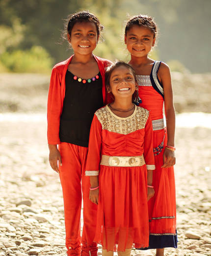 Image of young Nepalese children smiling at the camera - KILROY