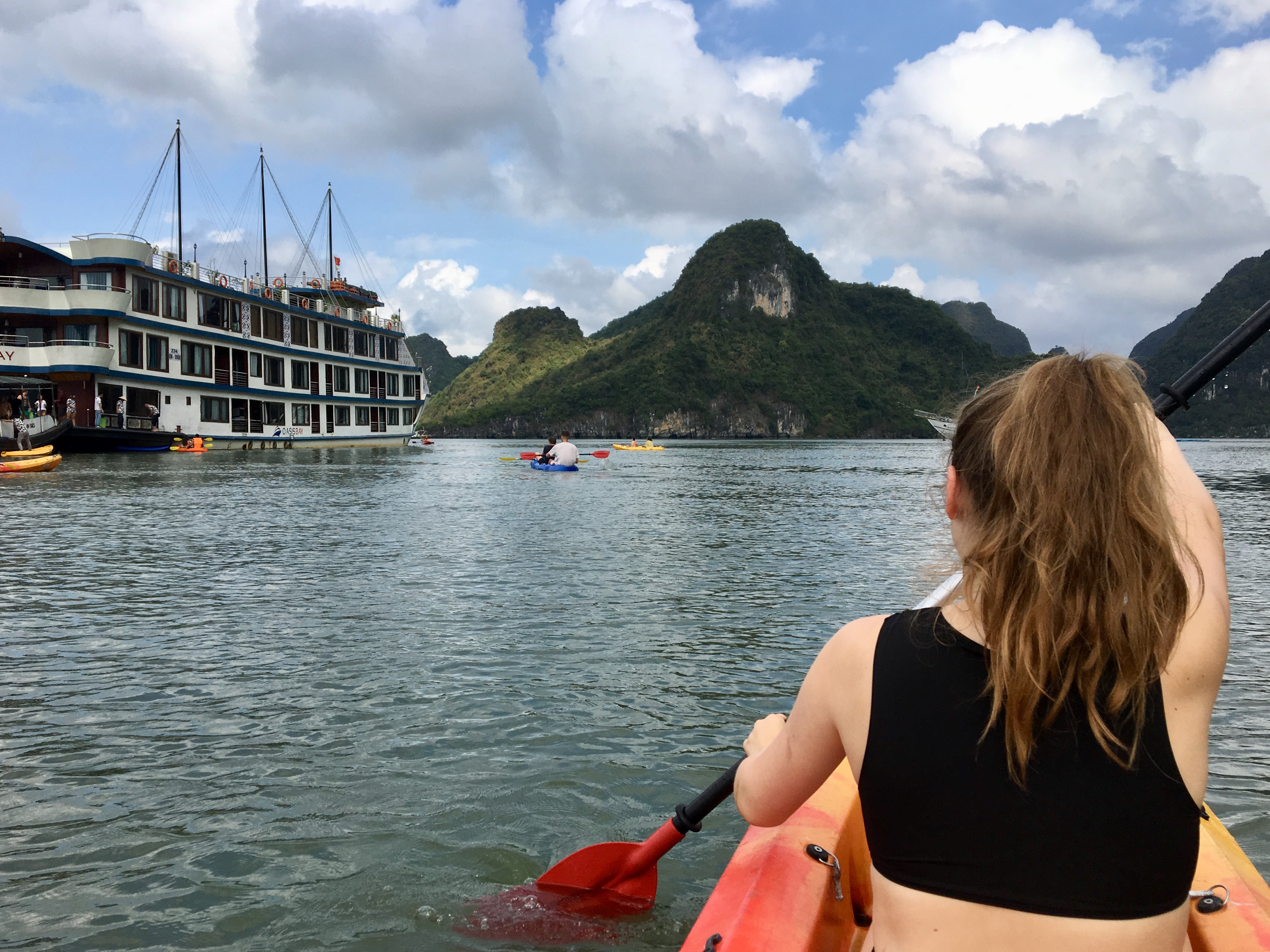 Image of a female traveller on a kaya in Halong Bay in the north of Vietnam - KILROY
