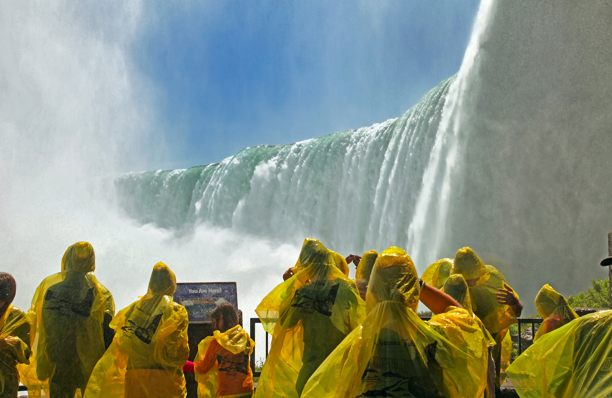 Image of people in rain ponchos visiting Niagara Falls in eastern Canada - KILROY