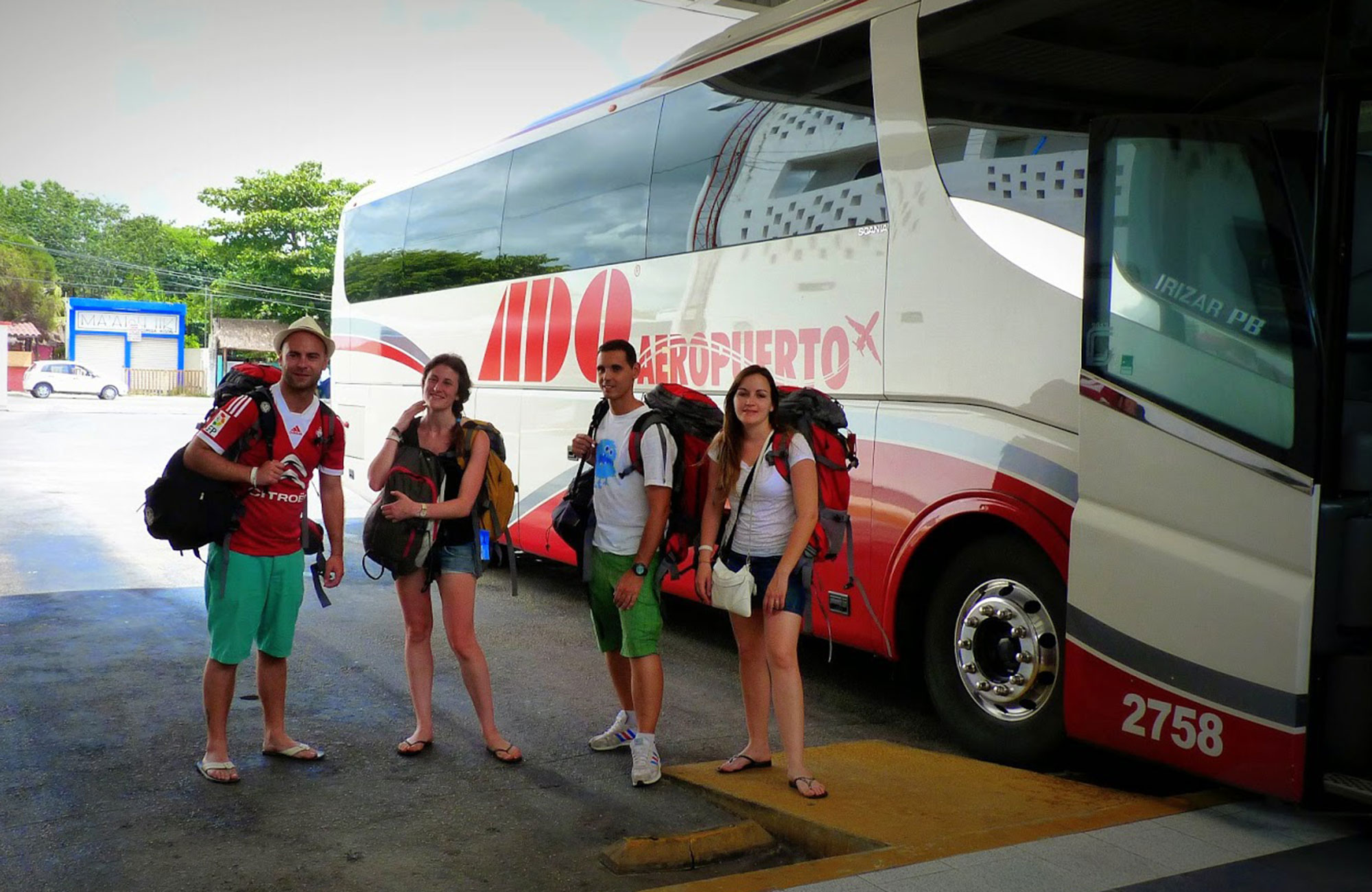 Image of a group of backpackers outside an ADO bus in Mexico - KILROY