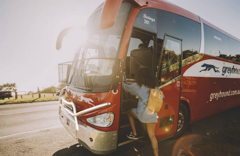 Image of a young female traveller boarding a Greyhound bus in Australia - KILROY