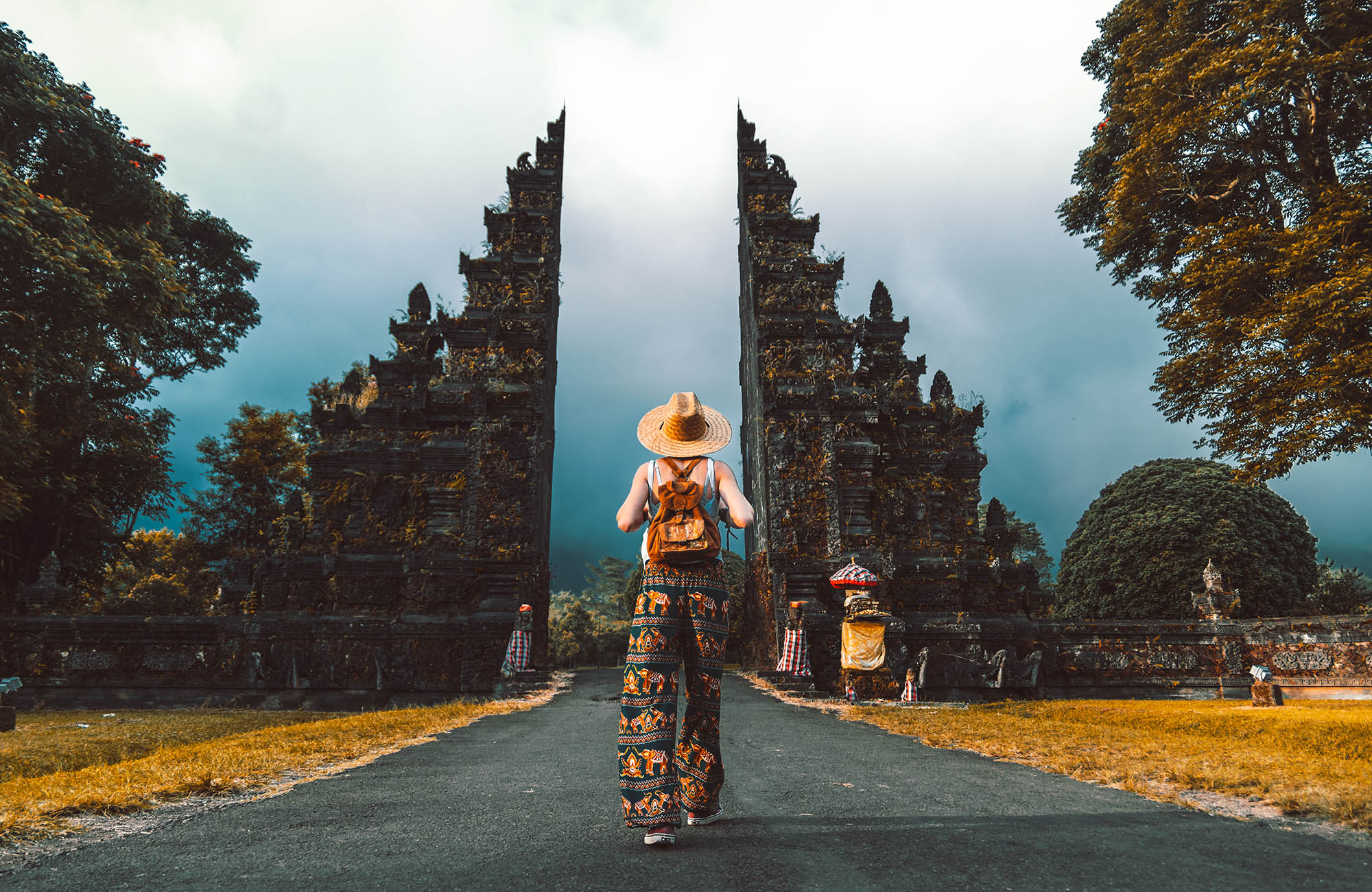 A young female traveller walks towards the famous Handara gate in Bali - KILROY