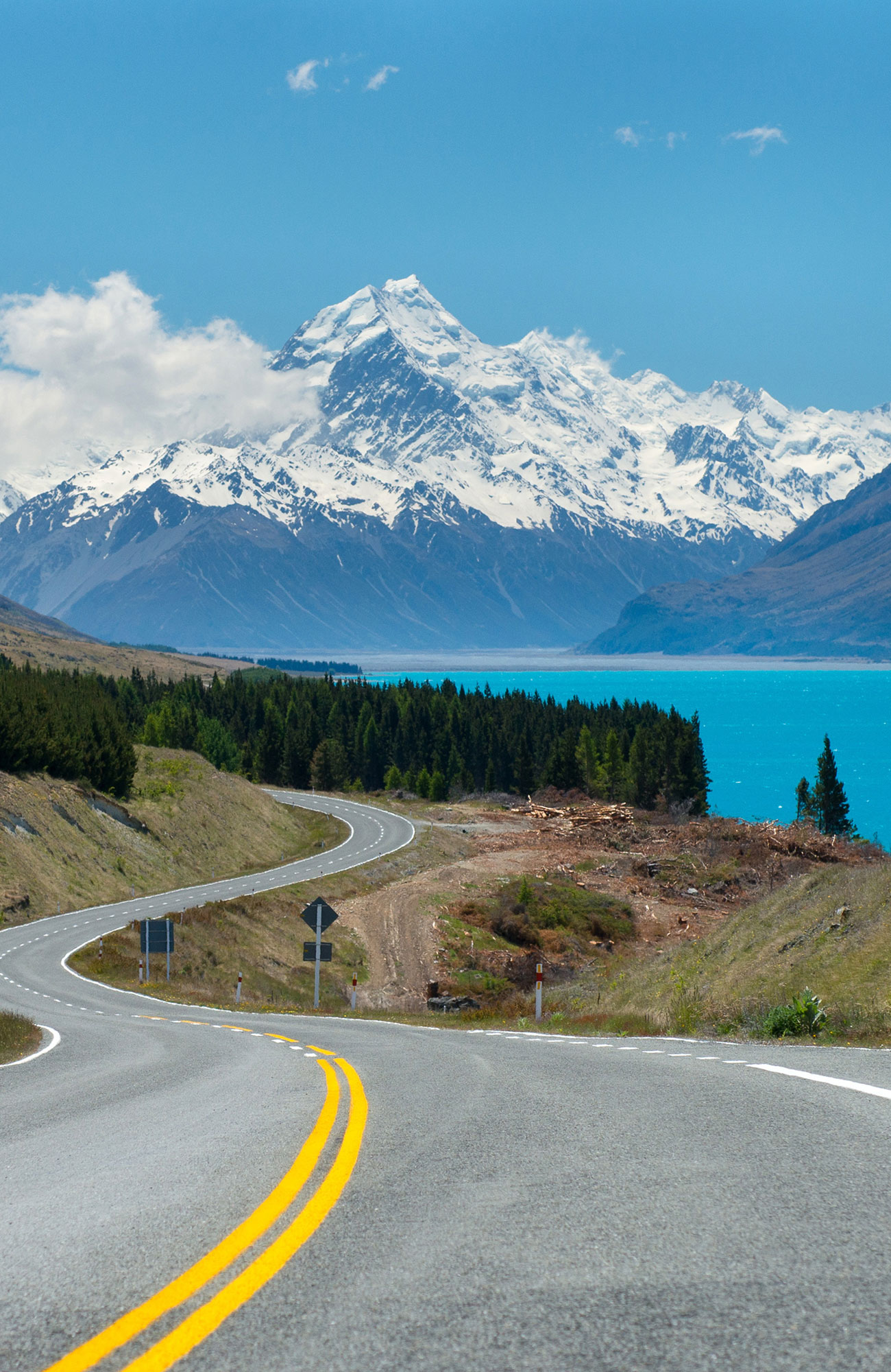 Image of a highway leading to snow-capped mountains in New Zealand - KILROY