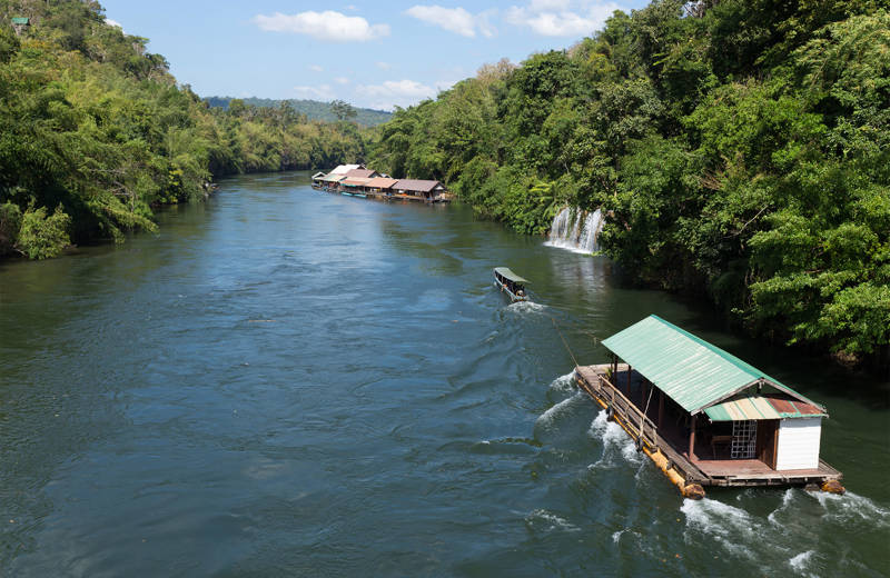 Traditional house boats on a river in the Sai Yok National Park in Thailand - KILROY