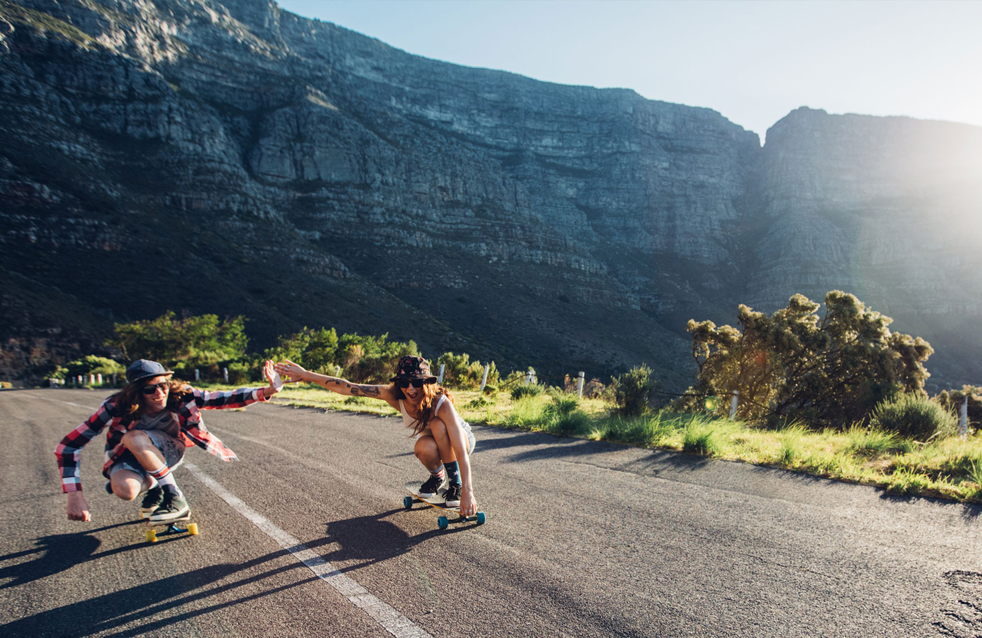 happy partnership between girl and guy skaters on road - KILROY UK