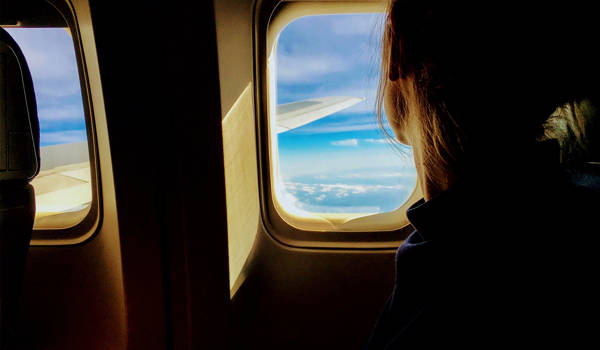 Traveling Alone Girl Looking Out Of A Plane
