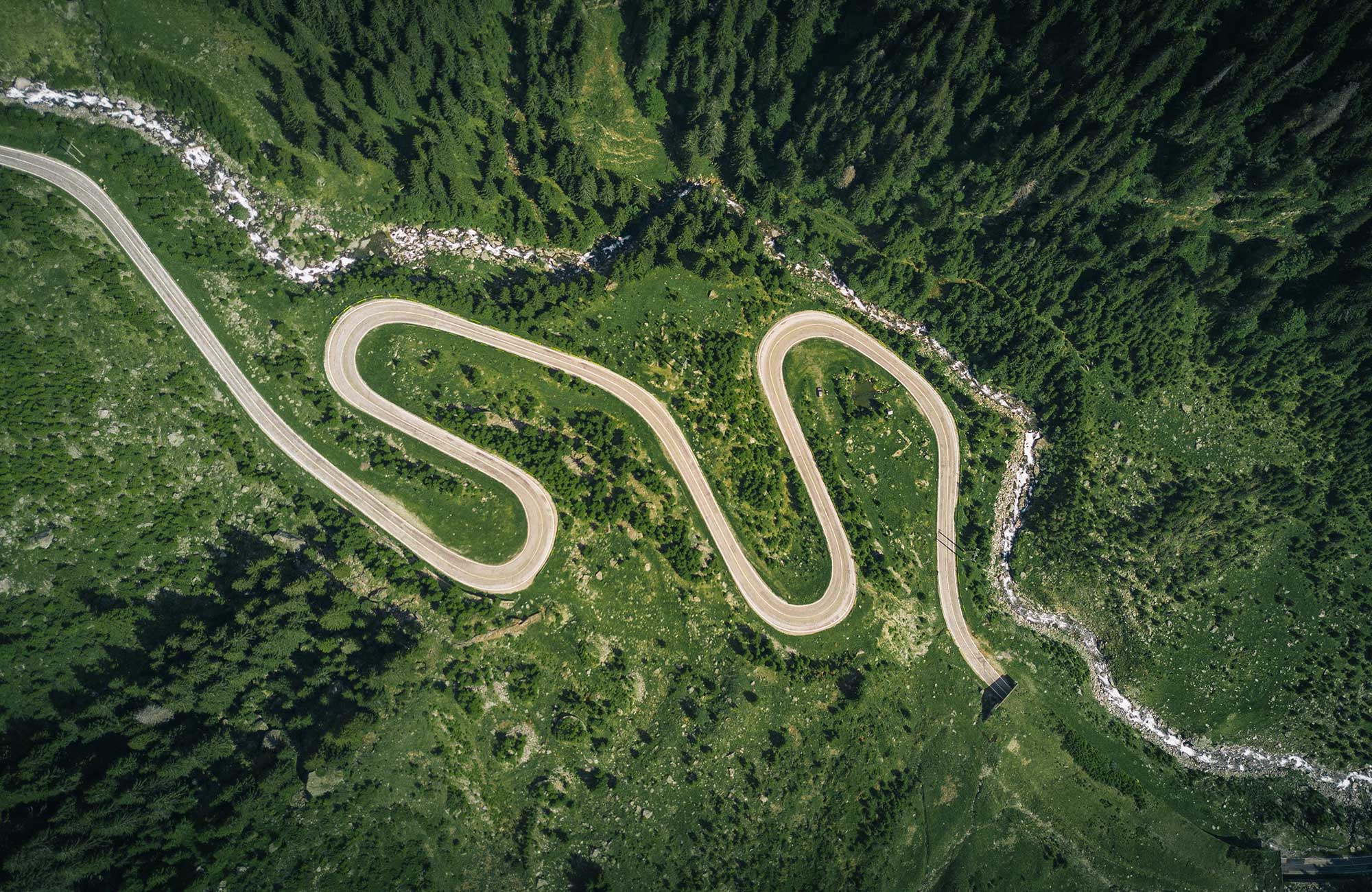 Aerial view of a winding road in Romania - KILROY UK