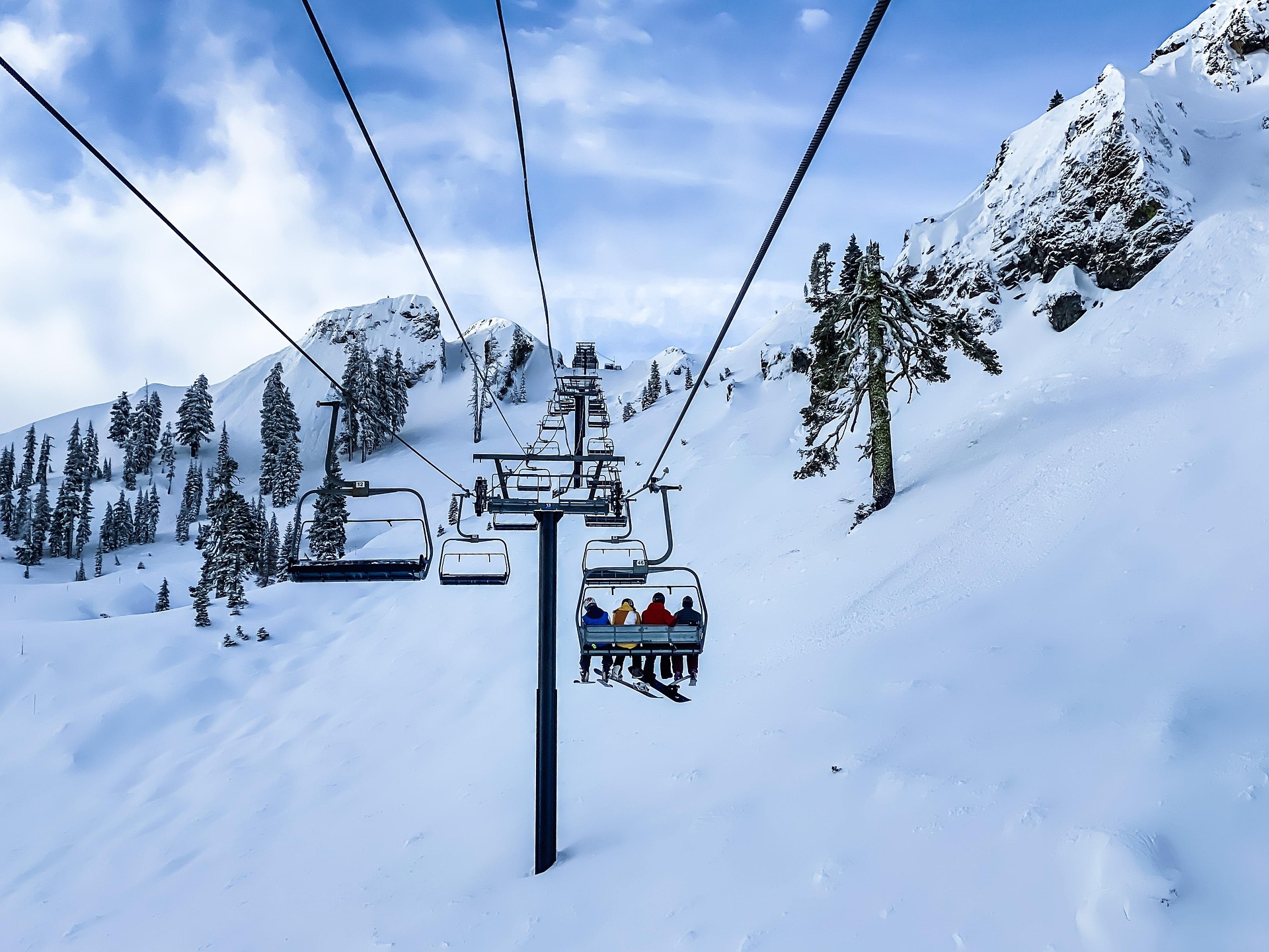 Image of people on a ski chair in a snowy landscape in Canada - KILROY