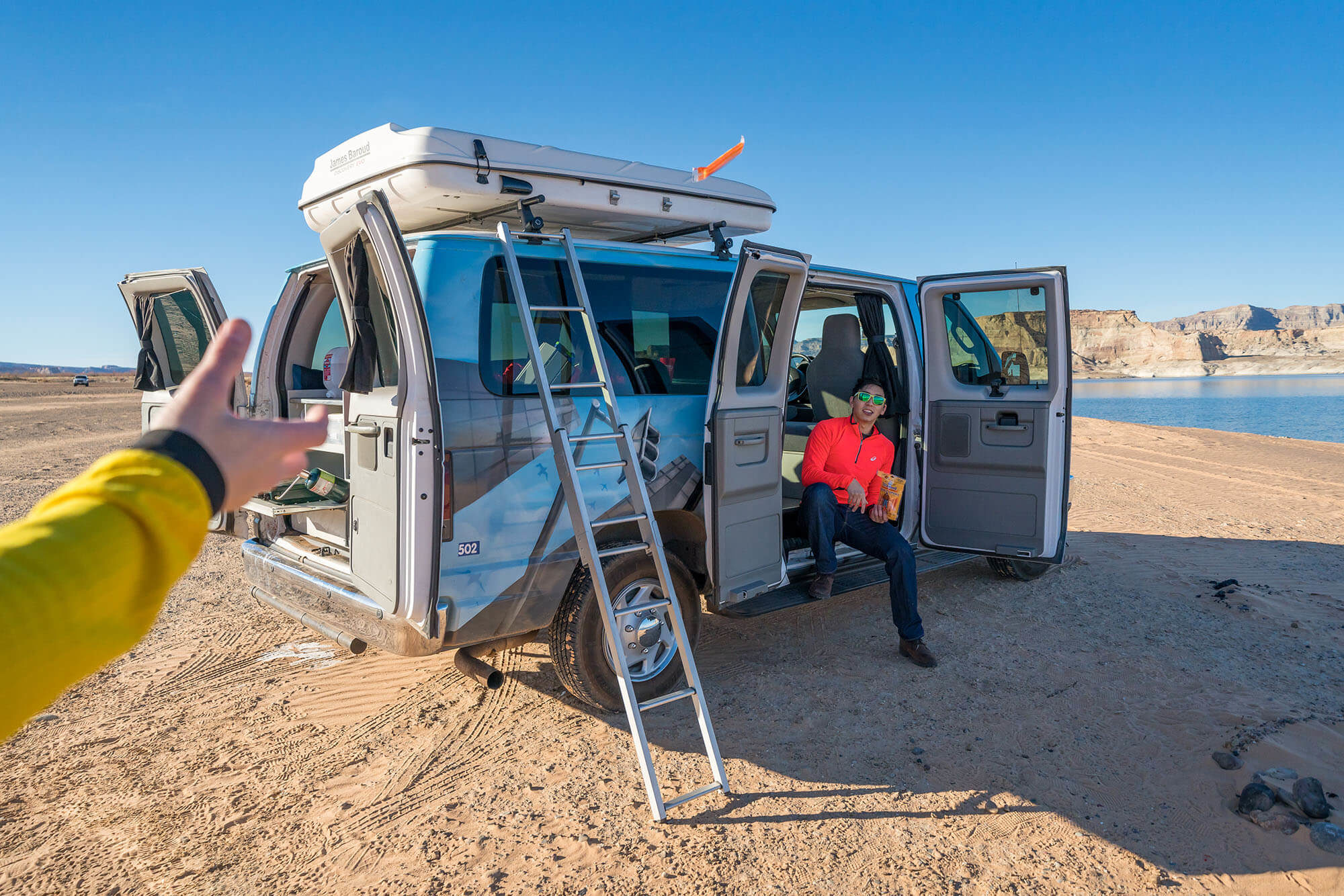 Image of a couple in a rented campervan on their backpacking trip - KILROY