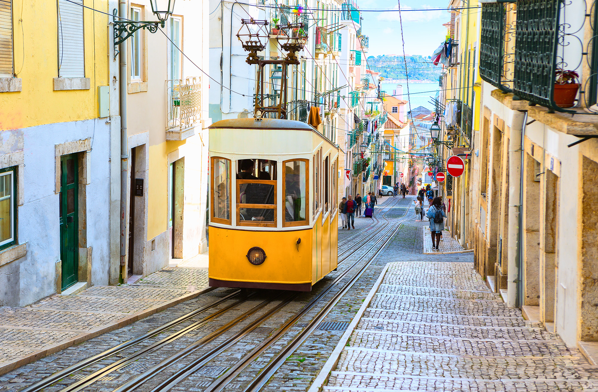 Image of a tram on a narrow street in Lisbon, the capital of Portugal - KILROY