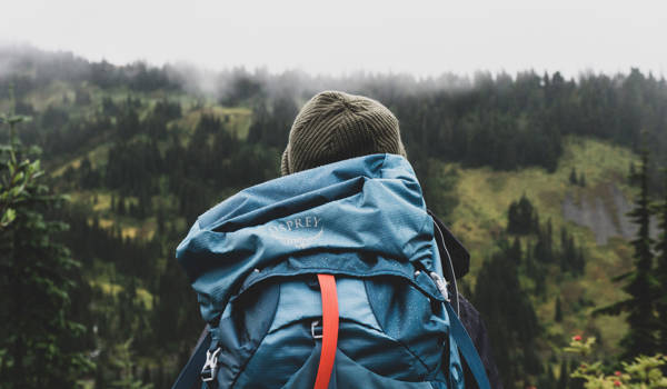 Backpacker In Misty Forest