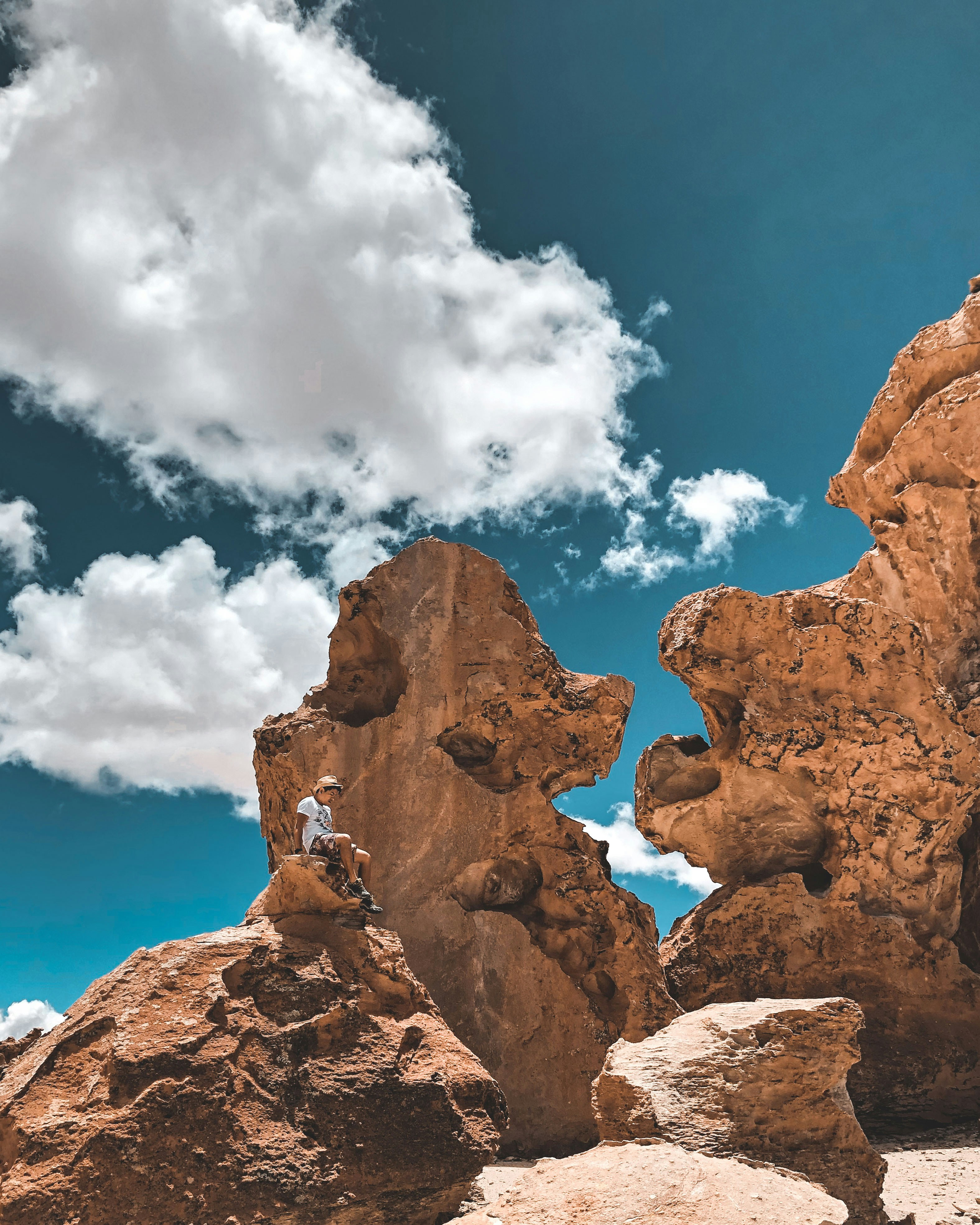 Image of a male traveller on a rock formation in Potosi in Bolivia - KILROY